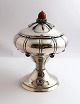Danish work. 
Silver 
bonbonniere on 
foot with 6 
amethysts and 
amber ball 
(830). Height 
19 cm. ...
