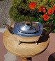 Sterling silver 
teapot on four 
legs of English 
tableware 
sterling silver 
with brown 
handle in a ...