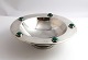 Mogens Björn 
Andersen (MBA). 
Round sterling 
silver bowl 
with 5 green 
stones. 
Diameter 16.5 
cm