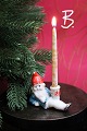 Old Christmas candlestick in painted bisque (porcelain) of Santa Claus lying down holding a ...