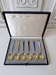 Set of 6 coffee 
spoons in 
gold-plated 
sterling silver 
and enamel 
decorated with 
a royal crown. 
...