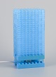 Scandinavian 
design. Table 
lamp in light 
blue plastic.
