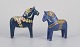 Two Dala 
horses. 
Hand-painted 
with floral 
motifs on a ...