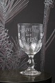 Old French 
souvenir wine 
glass with 
engraved 
writing and 
decorations. 
"Souvenir de la 
feté" ...