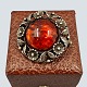 N. E. From; A 
brooch of 
sterling silver 
set with amber