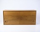 Low 
wall-mounted 
bookcase in 
rosewood with 
front door and 
characteristic 
round handles, 
designed ...