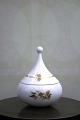 Small Rosenthal 
Bjorn Wiinblad 
lidded jar in 
white porcelain 
with gold 
decorations. H: 
11cm. ...