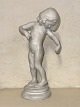 Venus 
Kalypogos: 
White glazed 
ceramic figure 
of a standing 
girl on a round 
base. Made by 
the ...