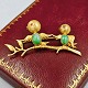 Brooch made of 
14 kt. gold 
with motif of 
two birds on a 
branch. Set 
with ruby and 
jade.
L. 4.7 ...
