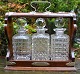 English 
tantalus with 
three crystal 
decanters, 19th 
century. 
Polished oak. 
With brass 
fittings ...