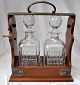 English 
tantalus with 
two crystal 
decanters, 19th 
century. With 
metal fittings 
and lock with 
...