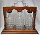 English 
tantalus with 
three crystal 
decanters, 19th 
century. Oak. 
With brass 
fittings and 
lock ...