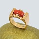 Ring in 14k 
gold, set with 
a coral