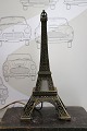 Old miniature Eiffel Tower in metal with light inside. ...