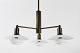 Poul Henningsen (1894-1967)Chandelier of brass with brown patinamounted with white opal ...