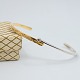 Gold bangle in 14k gold and white gold, set with a diamond mounted in white gold.Inner ...
