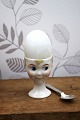 Old egg cup from the 1930s in porcelain with a painted funny face. Height: 6.5cm.