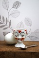Old egg cup from the 1930s in porcelain with a painted funny face. Height: 6cm.