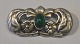 Bernhardt Hertz (18993 - 1937) Copenhagen, Denmark: Jugend silver brooch. With green stone. ...