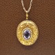Medallion in 14 kt. gold with amethyst, surrounded by small pearls. Can be opened at the ...