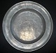 Pewter dish, 18th century. With stamps and engravings. Engraving on the front: PH.M and floral ...
