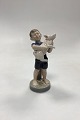 Royal Copenhagen Monthly Figurine August - Boy with Piglet No. 4530. Designed by Hans Henrik ...