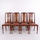Set of eight dining chairs crafted in dark wood with turned legs and upholstered in high-quality ...
