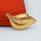 Ole Lynggaard gold jewelry. Ole Lynggaard; Brooch shaped like a leaf made of 14k gold. Set with ...