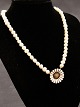 Pearl necklace with A Michelsen daisy brooch