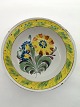 A kellinghusen 
fayance plate 
decorated with 
flower dia. 
24cm. rest.