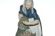 Royal Copenhagen,  Woman collecting potatoes
Dek. No 1549 
Length 20 cm. 
Height 26.5 cm.