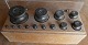 Weights in brass and in a box, all stamped. A total of 13 weights from 1kilo down to 1 gram.