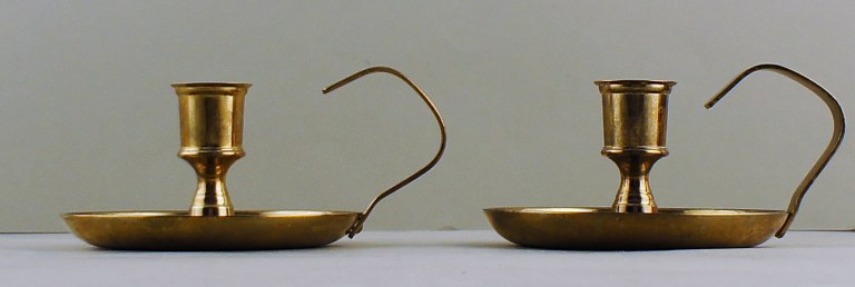 A pair of Skultuna, Sweden, brass chambersticks.