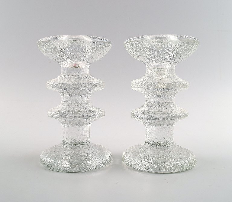 A pair of Iittala Festivo candlesticks, Design: Timo Sarpaneva.

