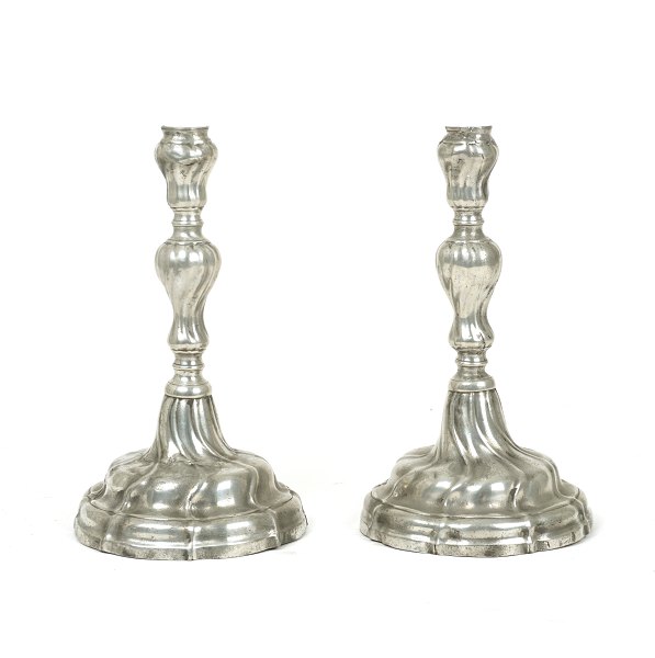 A pair of rokoko candle holders, tin