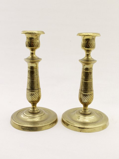 A pair of French empire brass candlesticks