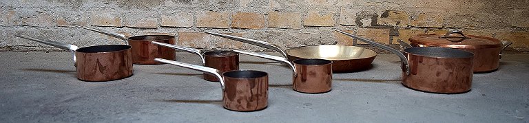 Henning Koppel for Georg Jensen: "Taverna". 8 pots and pan in copper, inner 
sides coated with silver.
