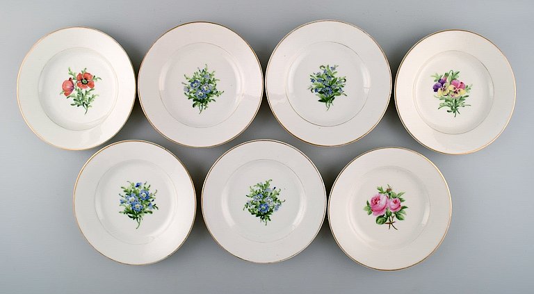 7 antique Royal Copenhagen plates in flora danica style.
