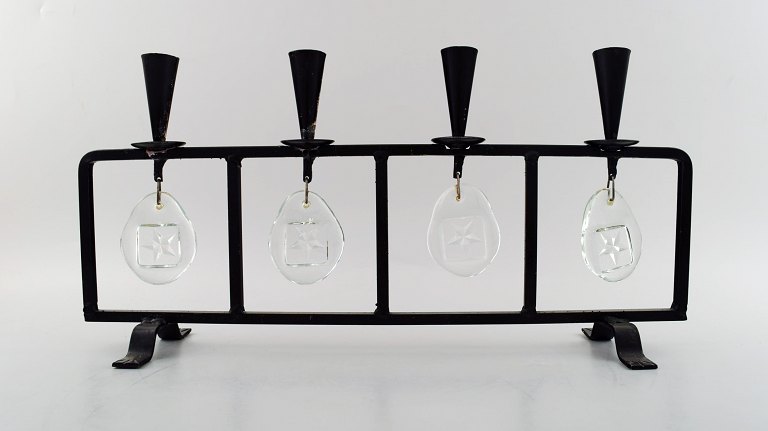 Erik Höglund for Kosta Boda, candleholder in cast iron with mouth blown glasses.