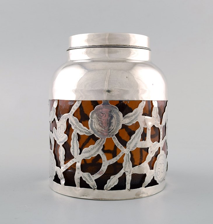 Tea caddy / lidded jar. Sterling silver / glass.
Tea caddy / lidded jar in smoked colored glass and sterling silver with 
filigree.