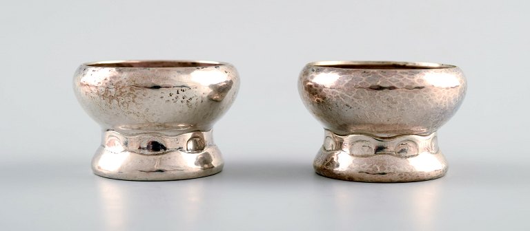 Two Evald Nielsen, Denmark art nouveau salt cellars, hammered silver. 1910s.