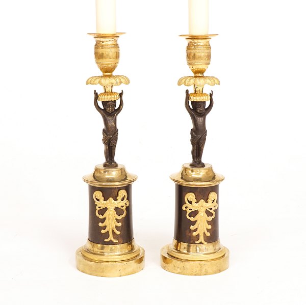 A pair of gilt bronze candle sticks. France circa 1820. H: 24cm