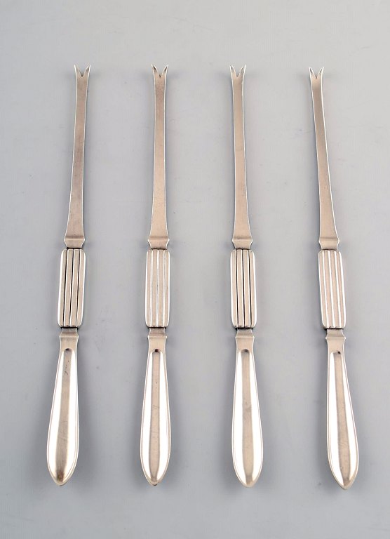 Four Georg Jensen Silver Bernadotte lobster forks.
