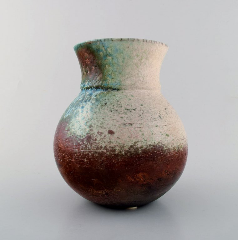 Dan Leonette. Swedish ceramist. Unique ceramic vase in red crystal glaze with 
shades of blue and white. 1970 s.
