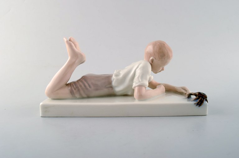 Rare Bing & Grondahl / B&G art nouveau porcelain paper weight, boy with crab. 
Ca. 1920.
