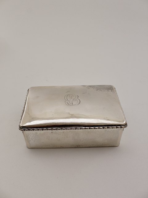 Three-tailed silver cigarette box