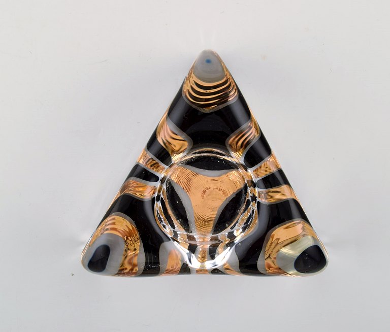 Ulrica Hydman Vallien for Kosta Boda, Sweden. Triangular candlestick in clear 
mouth blown art glass decorated with gold and black.