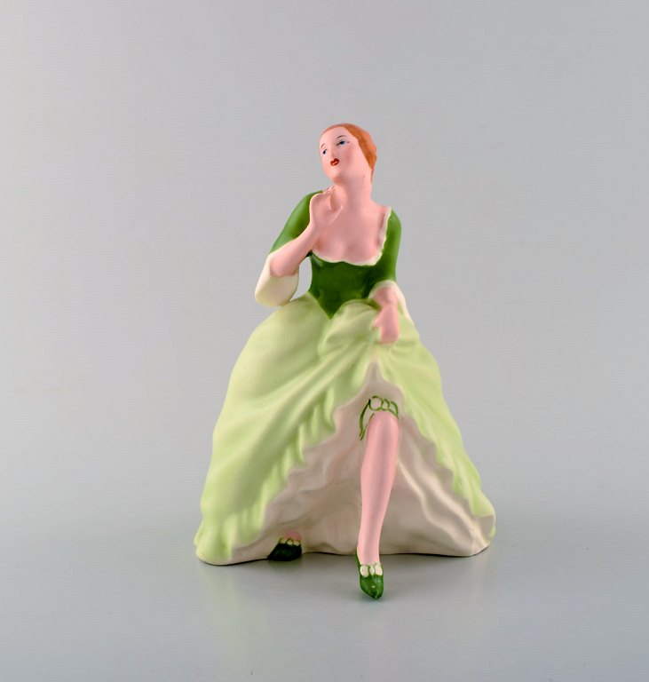 Art deco Royal Dux hand-painted porcelain figurine. Woman in light green dress 
with skirt. Czech Republic, 1940