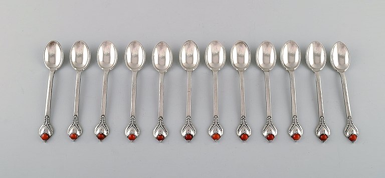 Evald Nielsen number 3 tea spoon. Set of 12 tea spoons in hammered silver with 
cabochon coral bead. 1920
