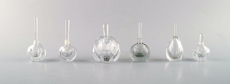 Vicke Lindstrand for Kosta Boda and Edward Hald for Orrefors. A collection of 
six mouth blown perfume bottles in clear art glass.
